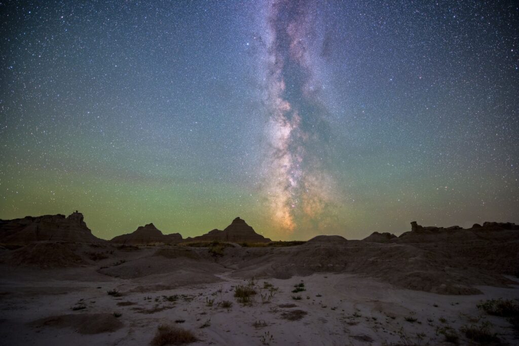 BADLANDS NATIONAL PARK IS NOW AN INTERNATIONAL DARK SKY PARK — WHAT IT MEANS FOR STARGAZERS 1 The milky way arching over the rock formations of badlands national park at night